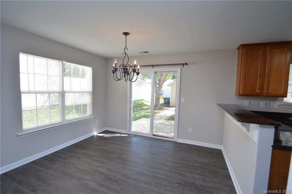 10044 Caldwell Depot Road Cornelius, NC 28031 - Photo 6 of 16 a view of an empty room with wooden floor and a window