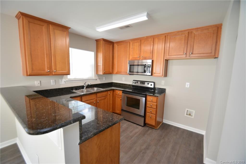 10044 Caldwell Depot Road Cornelius, NC 28031 - Photo 8 of 16 a kitchen with stainless steel appliances granite countertop a stove a sink and a microwave