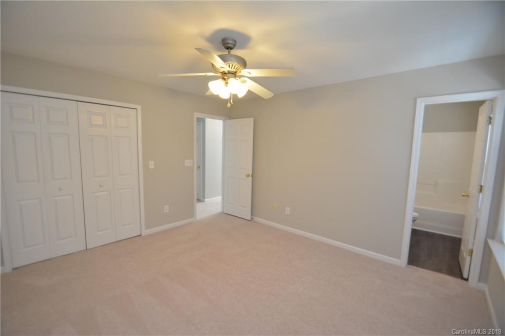 10044 Caldwell Depot Road Cornelius, NC 28031 - Photo 10 of 16 a view of an empty room with a fan