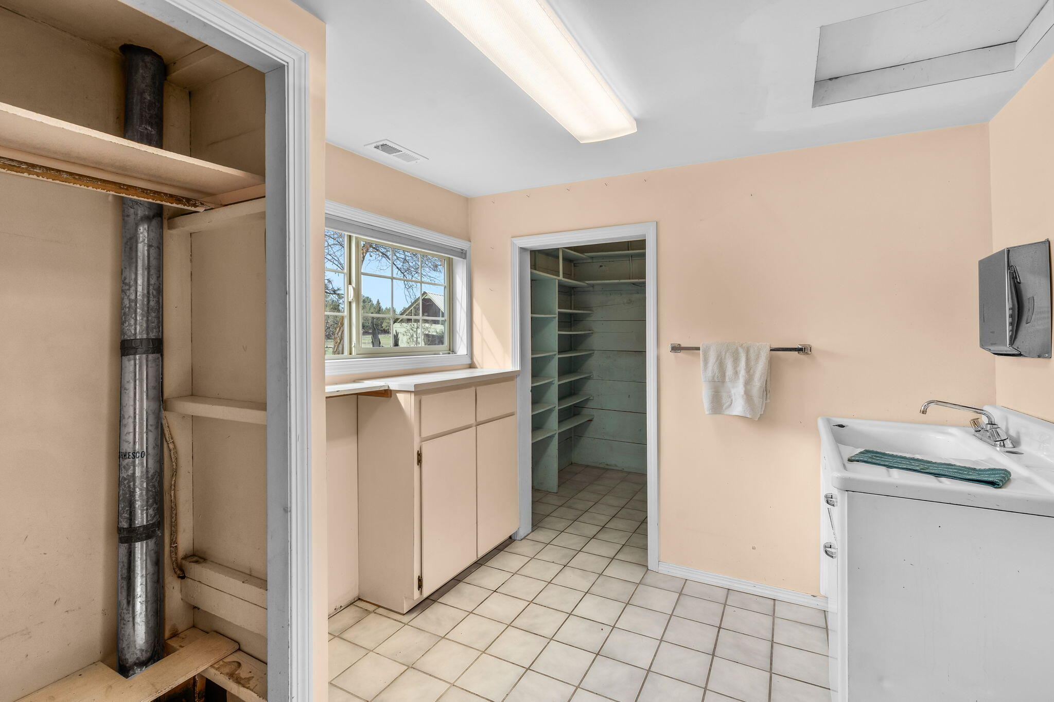 22655 Alfalfa Market Road Bend, OR 97701 - Photo 28 of 58 Large laundry room with pantry complete with canning shelves