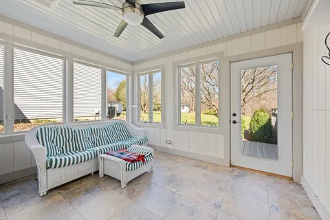 a living room with a baby crib furniture and a window