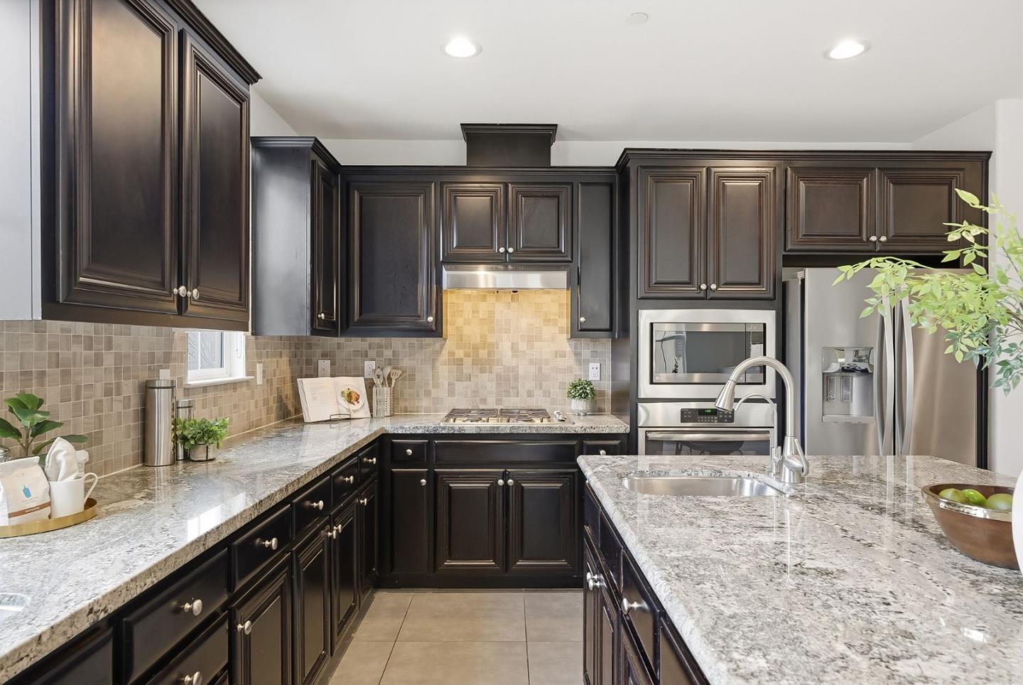 508 Holthouse Terrace Sunnyvale, CA 94087 - Photo 11 of 56 a kitchen with stainless steel appliances granite countertop a sink stove and refrigerator