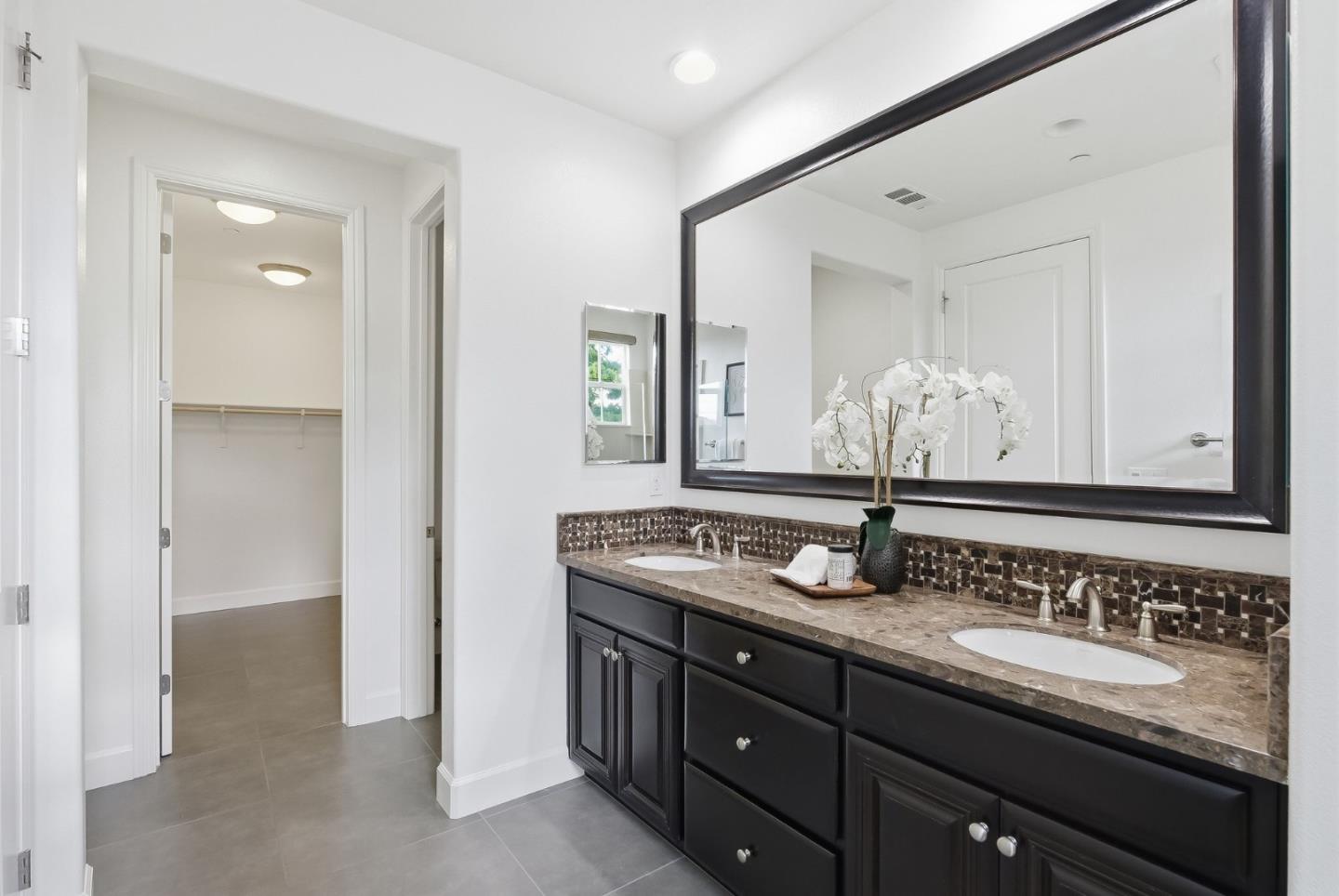 508 Holthouse Terrace Sunnyvale, CA 94087 - Photo 25 of 56 a bathroom with a granite countertop sink and a mirror