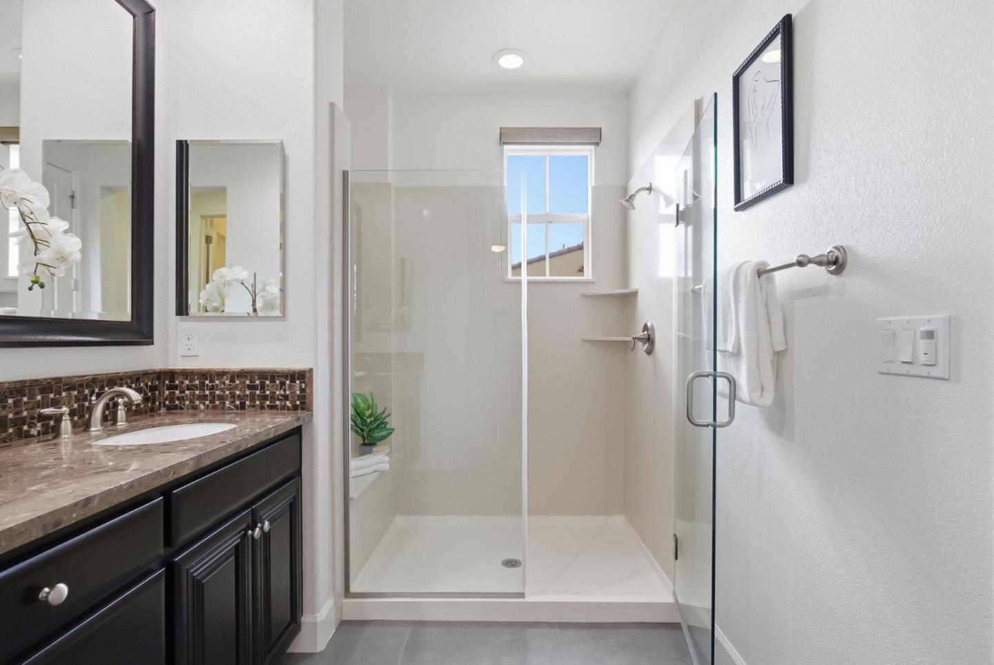 508 Holthouse Terrace Sunnyvale, CA 94087 - Photo 26 of 56 a bathroom with a granite countertop sink a mirror and a shower