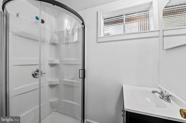 a bathroom with a sink and shower