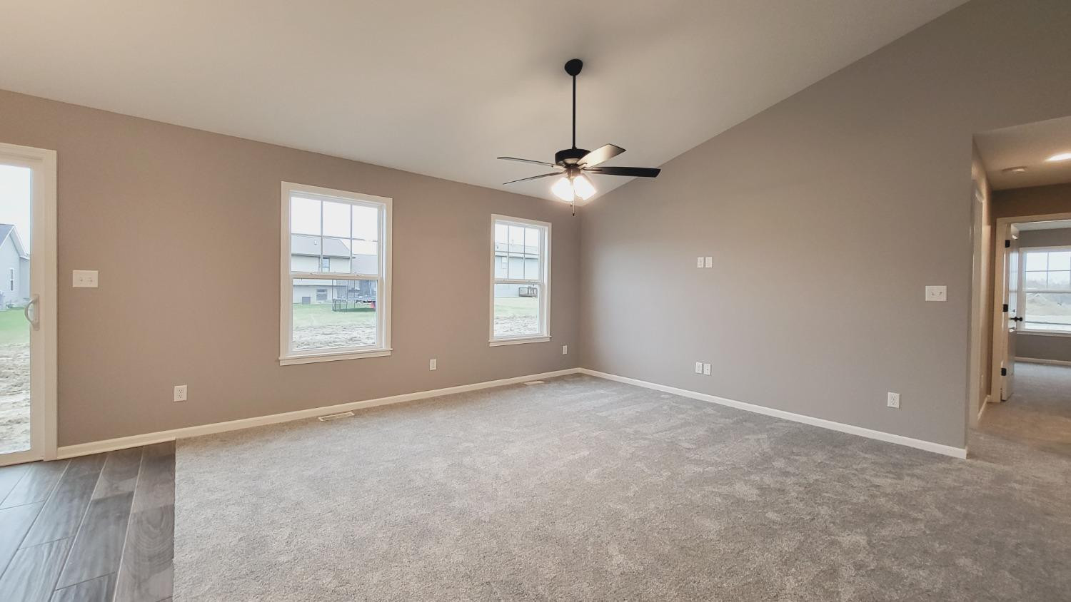 18348 Alexander Avenue Lowell, IN 46356 - Photo 10 of 24 an empty room with windows and chandelier fan