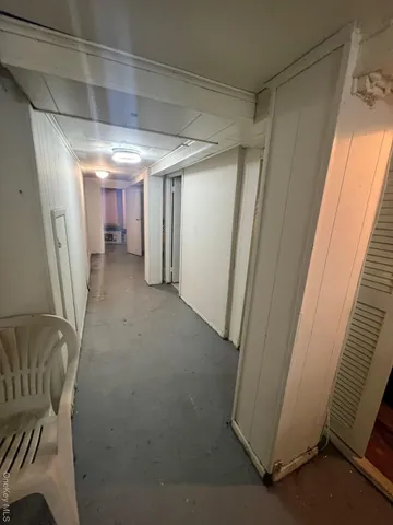 a view of a hallway with seating area