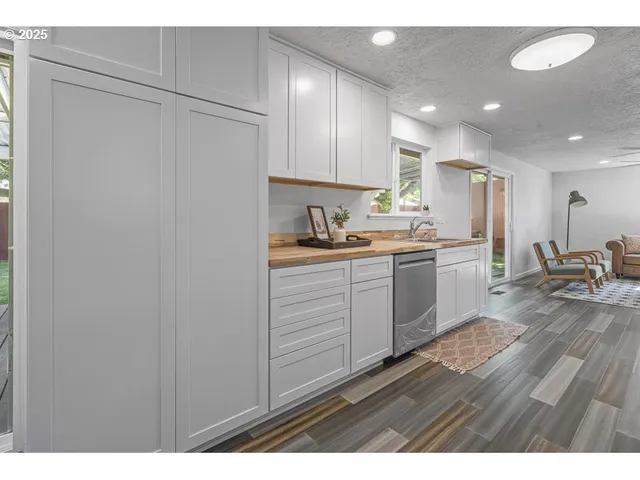 a kitchen with a sink stainless steel appliances and cabinets