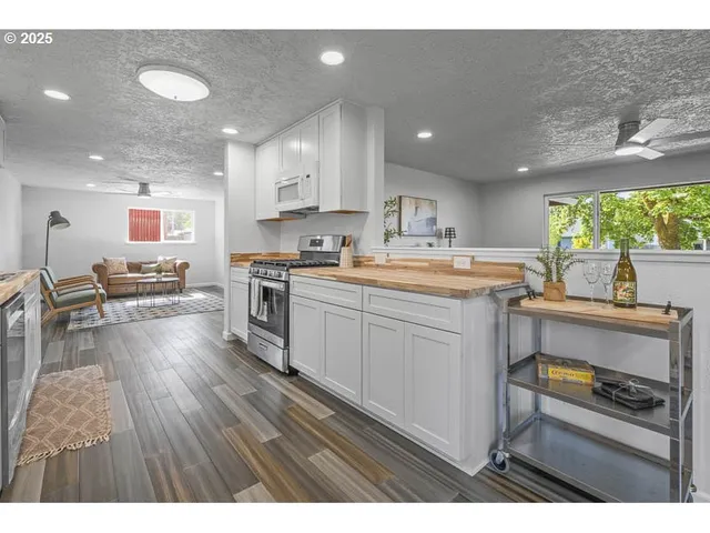 a kitchen with a sink stainless steel appliances and cabinets