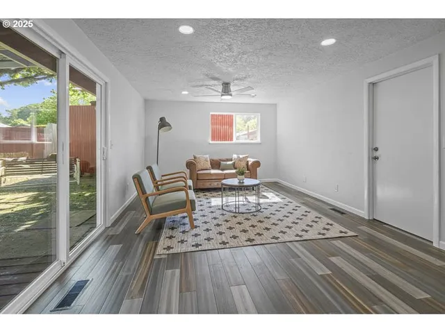 a living room with a couch and wooden floor