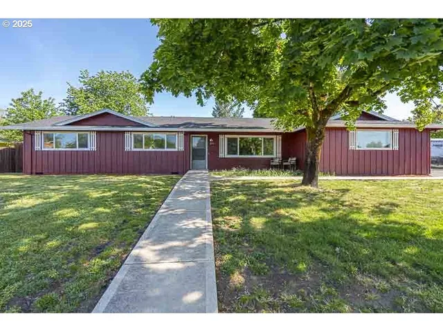 a front view of house with yard and green space