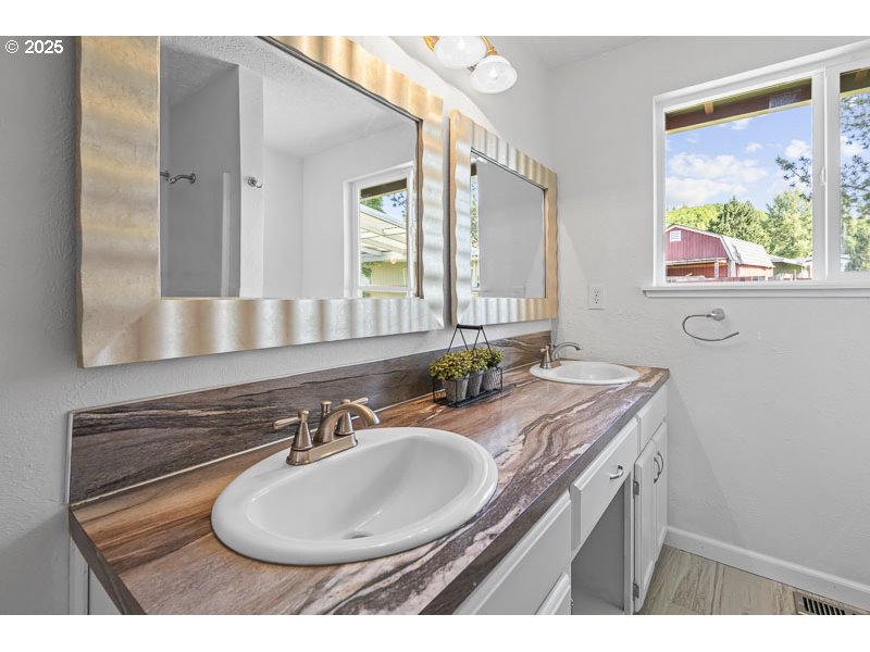 611 Northeast Bockes Loop Sheridan, OR 97378 - Photo 23 of 36 a bathroom with a sink and a mirror