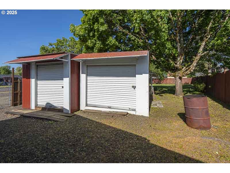 611 Northeast Bockes Loop Sheridan, OR 97378 - Photo 36 of 36 a backyard of a house with a yard and garage