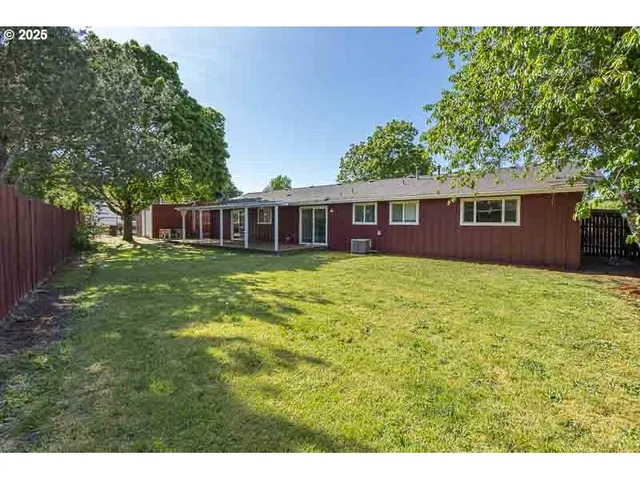a view of a house with yard and deck
