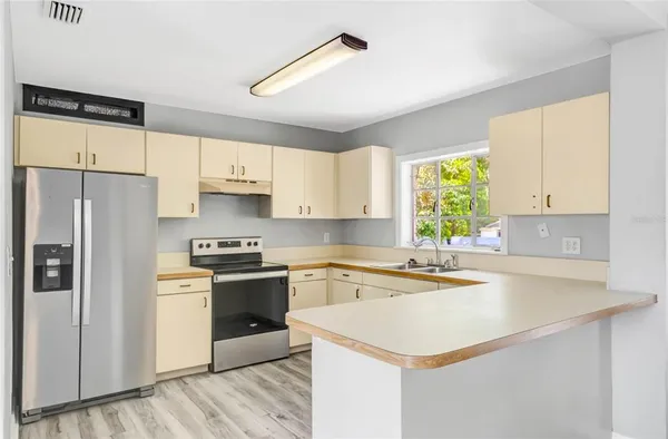 a kitchen with a white cabinets and white appliances