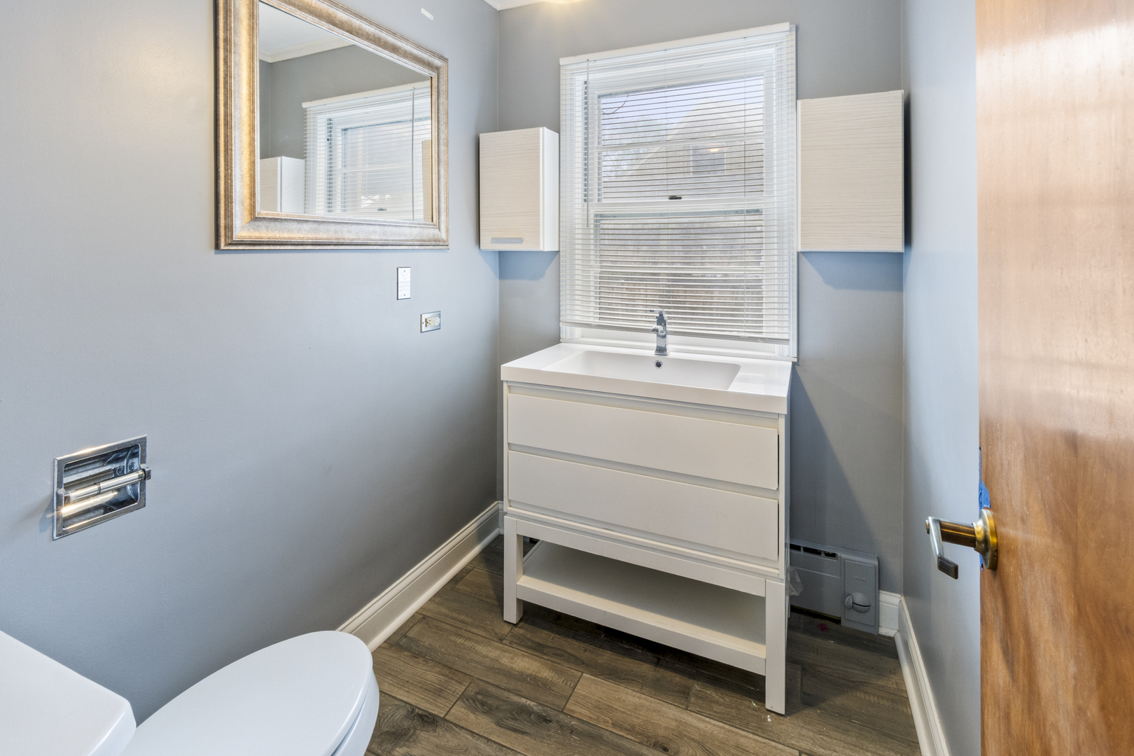 853 Orange Street Elgin, IL 60123 - Photo 13 of 28 a bathroom with a toilet sink and mirror