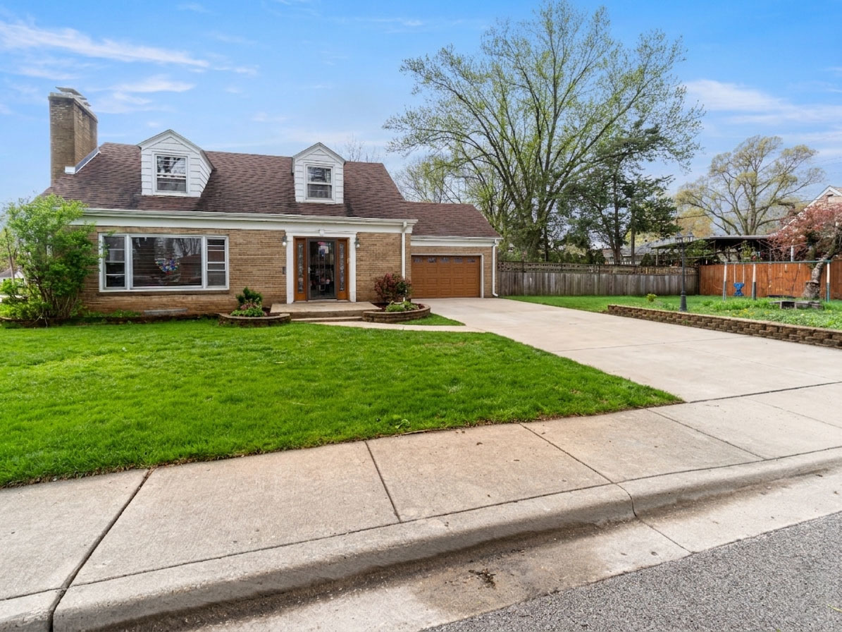 853 Orange Street Elgin, IL 60123 - Photo 19 of 28 a front view of a house with a garden and trees