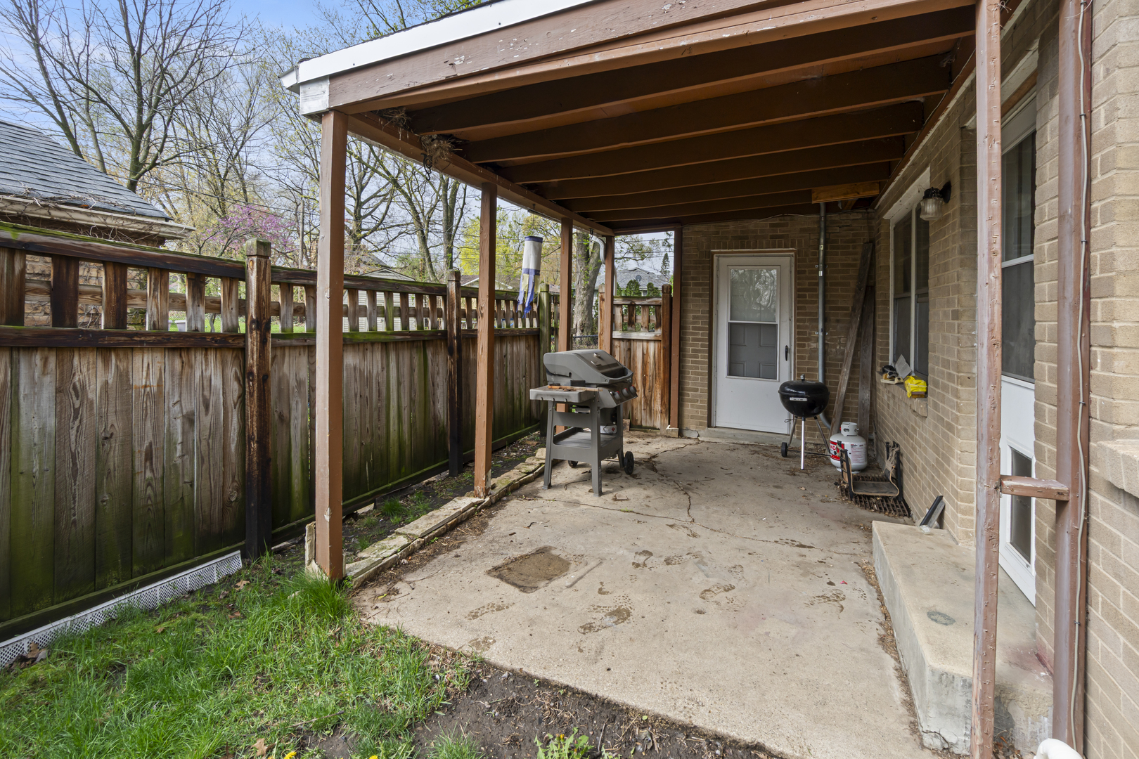 853 Orange Street Elgin, IL 60123 - Photo 22 of 28 a view of a backyard with sitting area and large tree