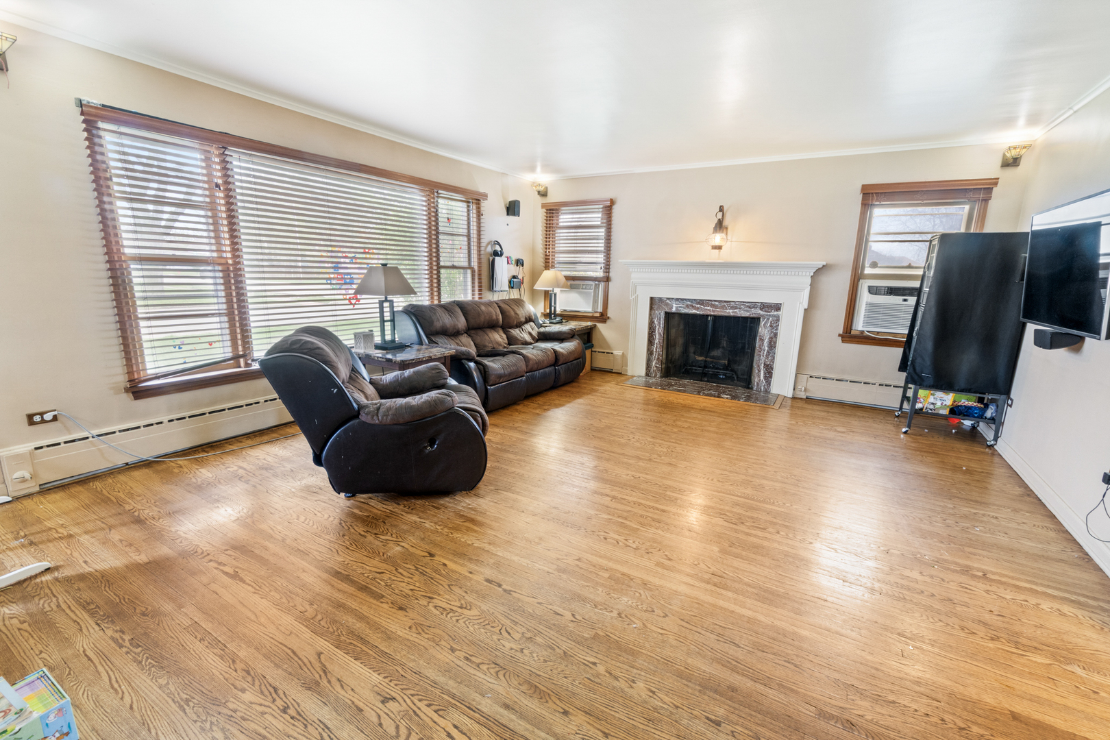 853 Orange Street Elgin, IL 60123 - Photo 4 of 28 a living room with furniture a fireplace and a flat screen tv