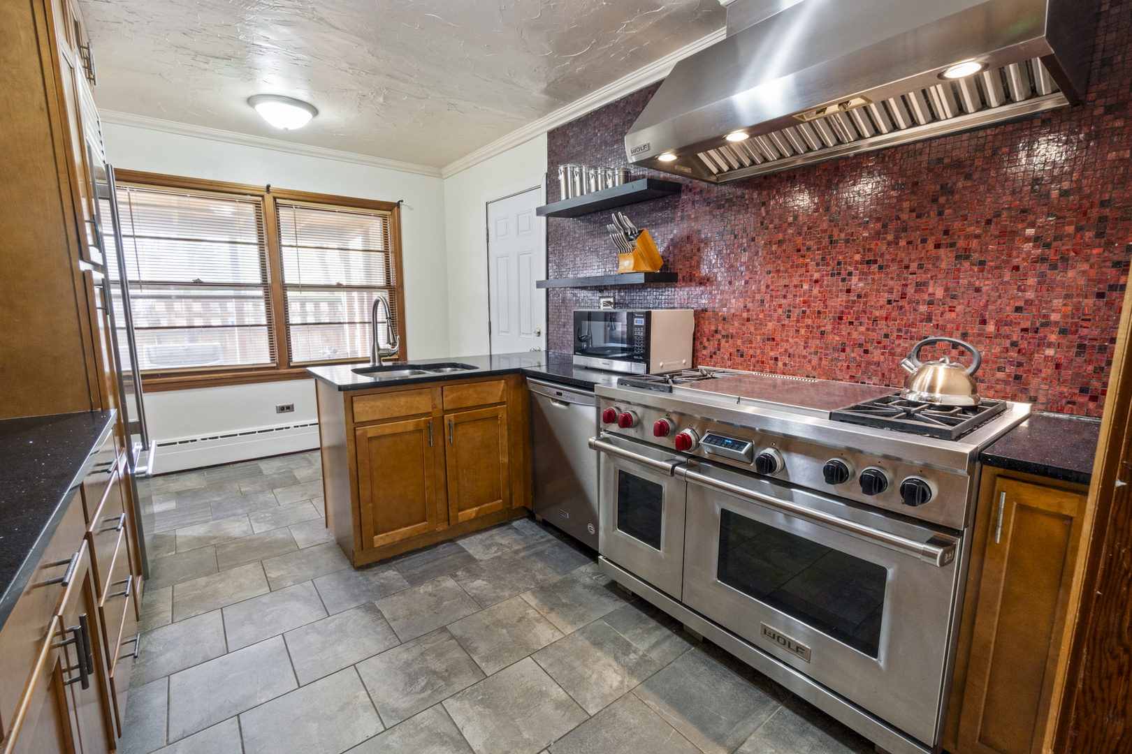 853 Orange Street Elgin, IL 60123 - Photo 6 of 28 a kitchen with stainless steel appliances granite countertop a stove and a sink