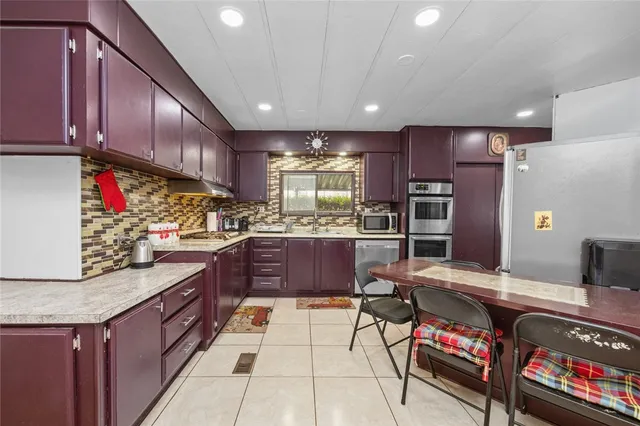 a kitchen with a refrigerator and a stove