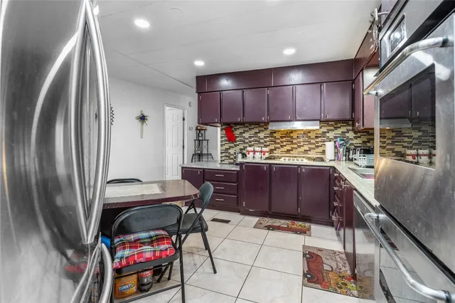 a kitchen with stainless steel appliances kitchen island granite countertop wooden cabinets a sink and dishwasher