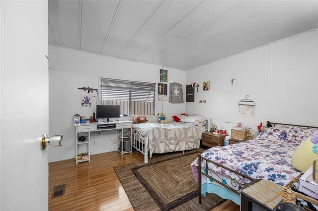 a bedroom with two beds and a dresser