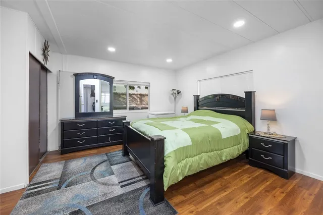 a spacious bedroom with a bed and a dresser