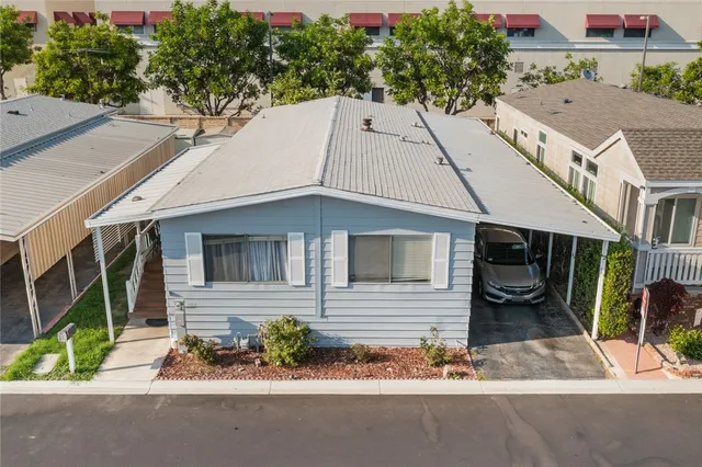 an aerial view of a house with a yard and potted plants