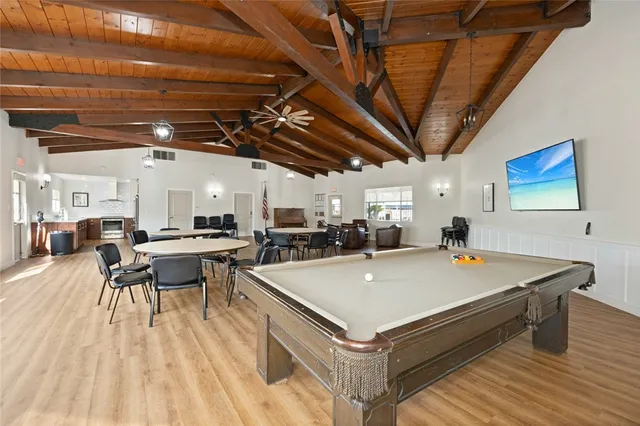 a gym room with lots of furniture and wooden floors