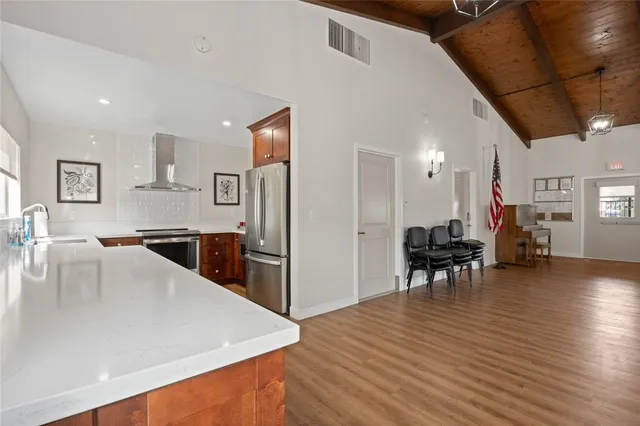 a room with gym equipment and a wooden floor