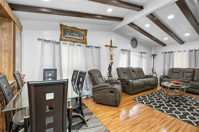 a kitchen with stainless steel appliances kitchen island granite countertop a stove refrigerator and cabinets