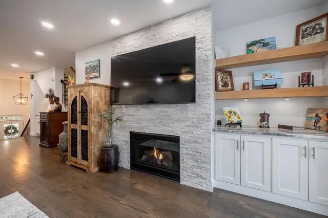 a living room with furniture and kitchen view