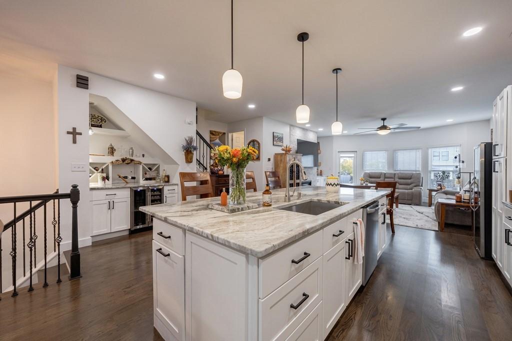 3908 Charleston Market Street Northwest Suwanee, GA 30024 - Photo 14 of 58 a kitchen with kitchen island a sink stove a center island with wooden floor