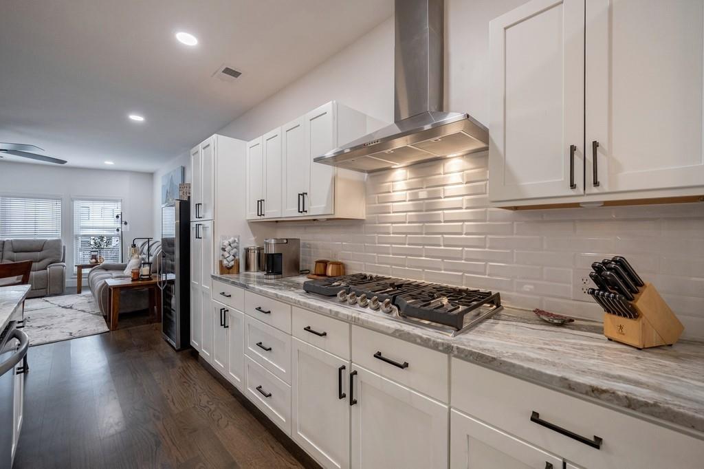 3908 Charleston Market Street Northwest Suwanee, GA 30024 - Photo 15 of 58 a kitchen with granite countertop a sink a stove and cabinets