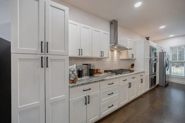 a kitchen with a refrigerator stove and microwave