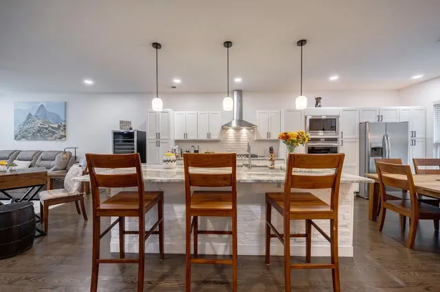 a kitchen with stainless steel appliances granite countertop a sink and cabinets