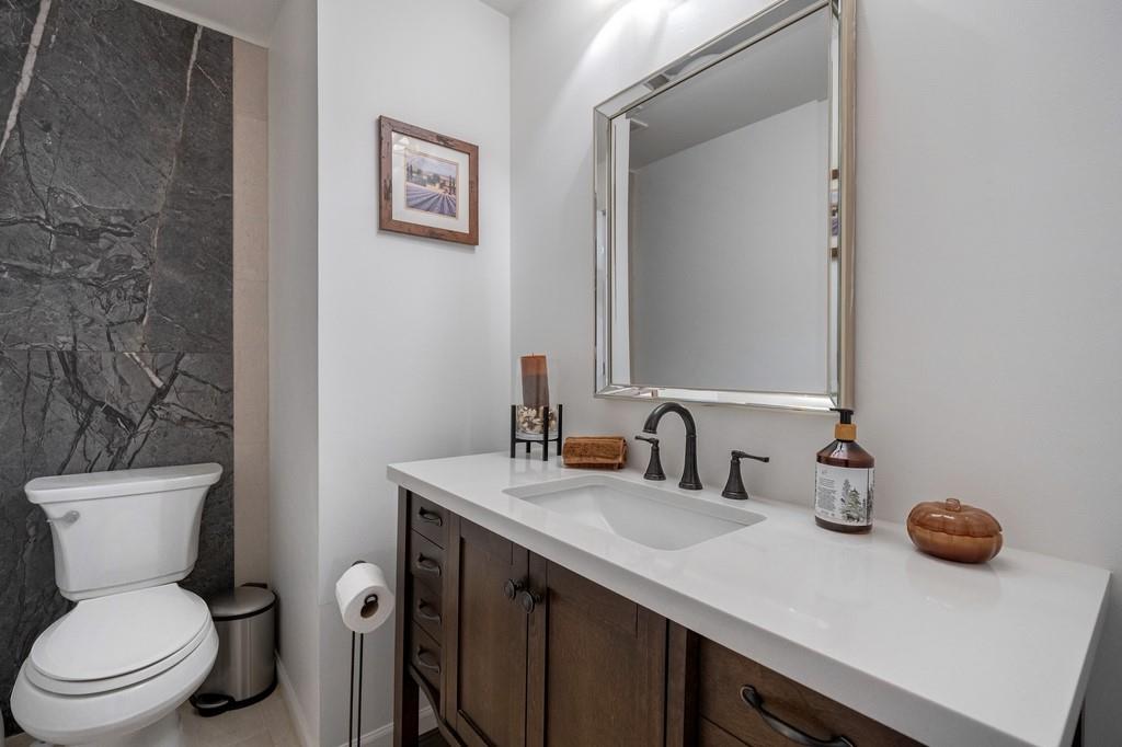 3908 Charleston Market Street Northwest Suwanee, GA 30024 - Photo 25 of 58 a bathroom with a toilet sink and mirror