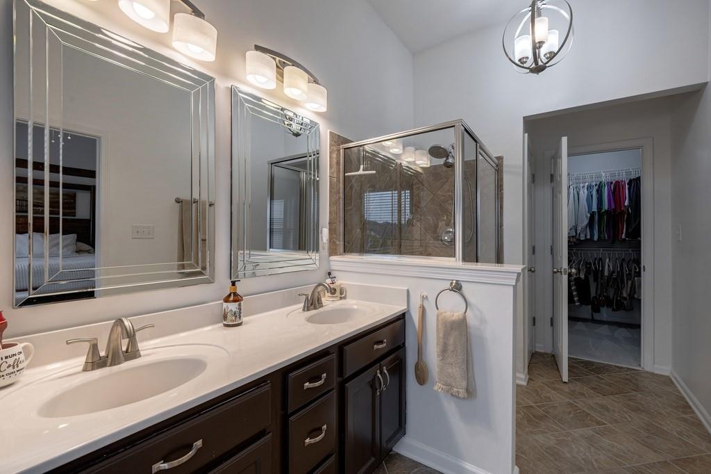3908 Charleston Market Street Northwest Suwanee, GA 30024 - Photo 29 of 58 a bathroom with double vanity and a mirror