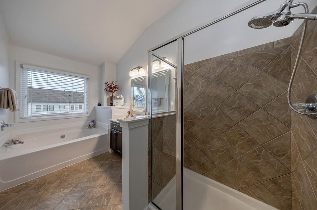 3908 Charleston Market Street Northwest Suwanee, GA 30024 - Photo 32 of 58 a bathroom with a bathtub and a sink