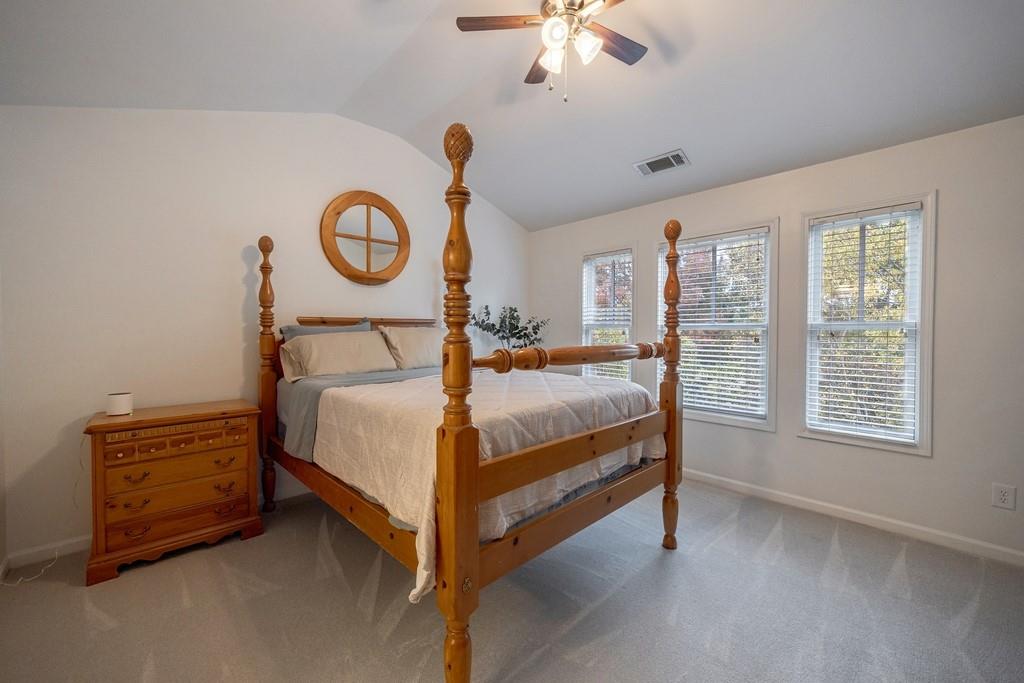 3908 Charleston Market Street Northwest Suwanee, GA 30024 - Photo 33 of 58 a bedroom with a bed and a chandelier