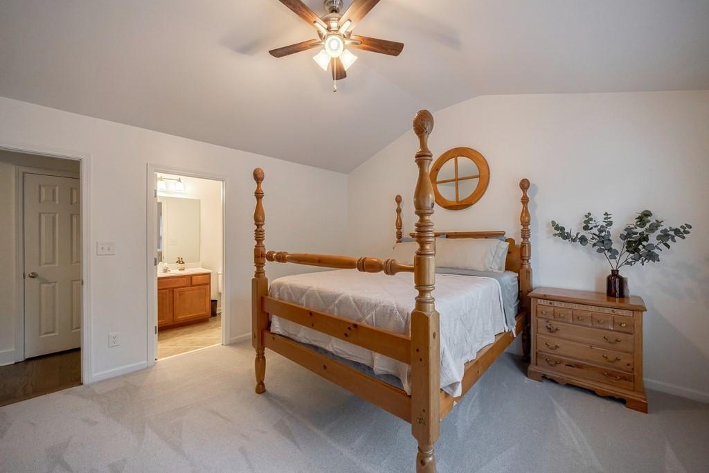 3908 Charleston Market Street Northwest Suwanee, GA 30024 - Photo 34 of 58 a bedroom with a bed and a chandelier