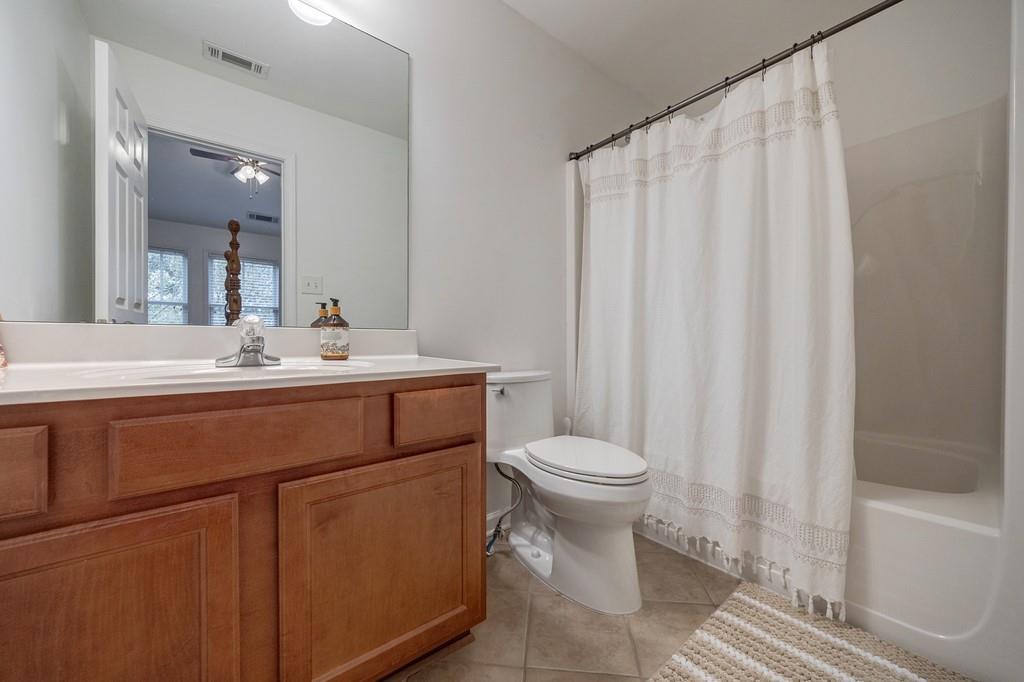 3908 Charleston Market Street Northwest Suwanee, GA 30024 - Photo 36 of 58 a bathroom with a sink a toilet and shower