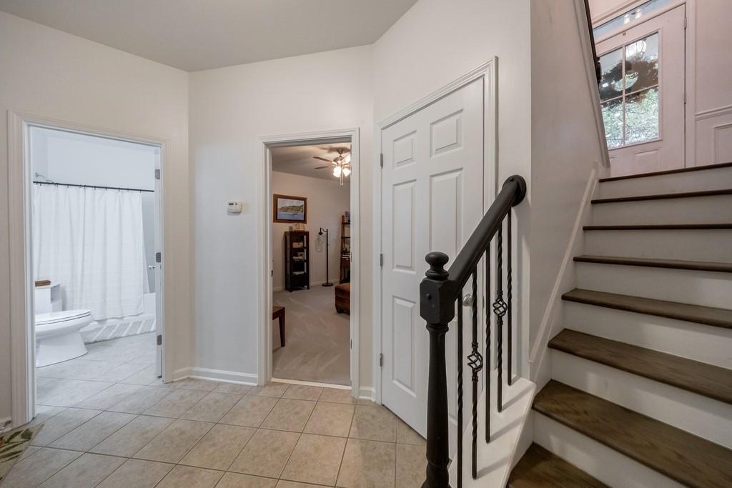 3908 Charleston Market Street Northwest Suwanee, GA 30024 - Photo 37 of 58 a view of a hallway with wooden floor and entryway