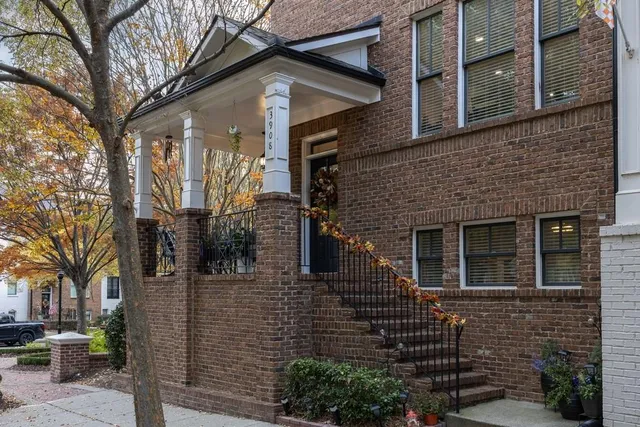 a front view of a house with a tree