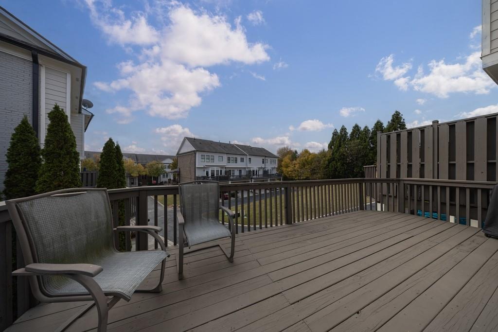 3908 Charleston Market Street Northwest Suwanee, GA 30024 - Photo 41 of 58 a balcony with wooden floor table and chairs