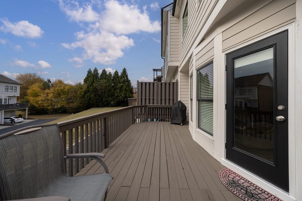 3908 Charleston Market Street Northwest Suwanee, GA 30024 - Photo 42 of 58 a view of balcony with wooden floor and fence