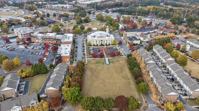 an aerial view of a swimming pool with outdoor seating