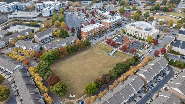 an aerial view of a house with swimming pool and lake view