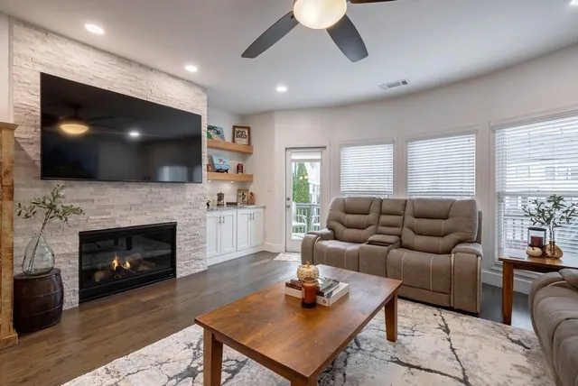 a living room with furniture a rug and a chandelier